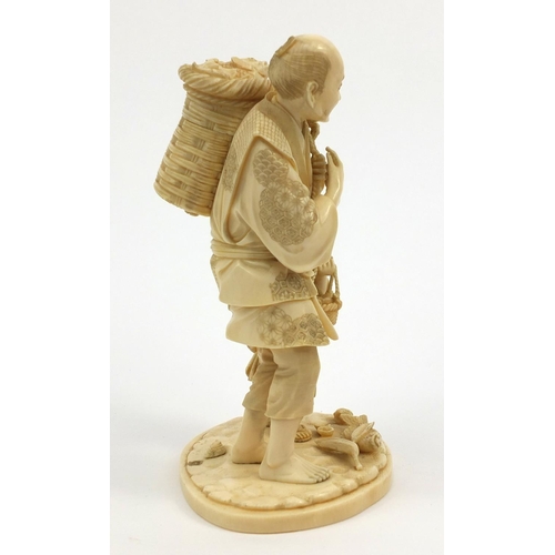 606 - Oriental Japanese ivory figure group of a fisherman carrying a basket of fish and a young boy, red s... 