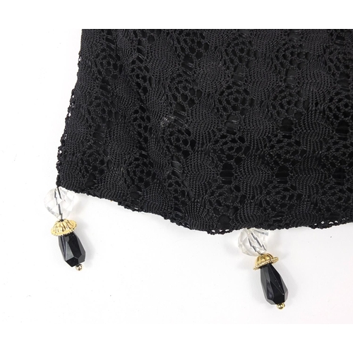 181 - Lady's crochet handbag with expanding metal top and clear and black glass tassels, 30cms tall