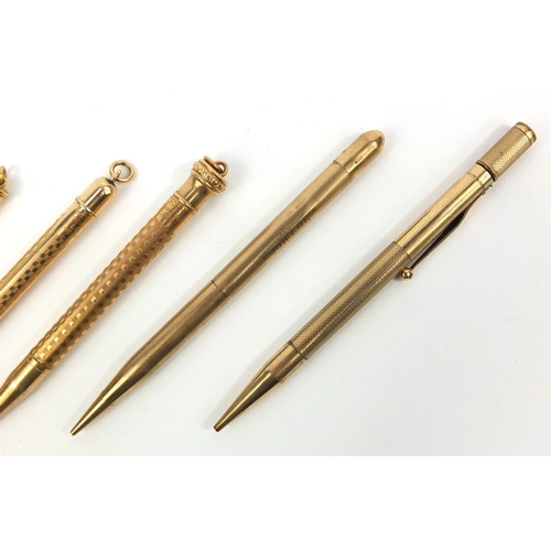 93 - Five propelling pencils including one 9ct gold example, the largest 12cm long