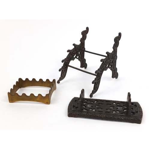 108 - Two Victorian cast iron pen stands and a brass example, the largest 12cms high