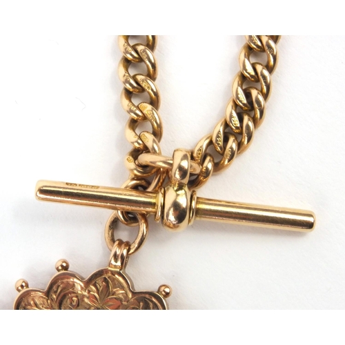 1286 - 15ct gold watch chain with T-bar and large 9ct gold hardstone spinner fob, the chain 36cm long, appr... 