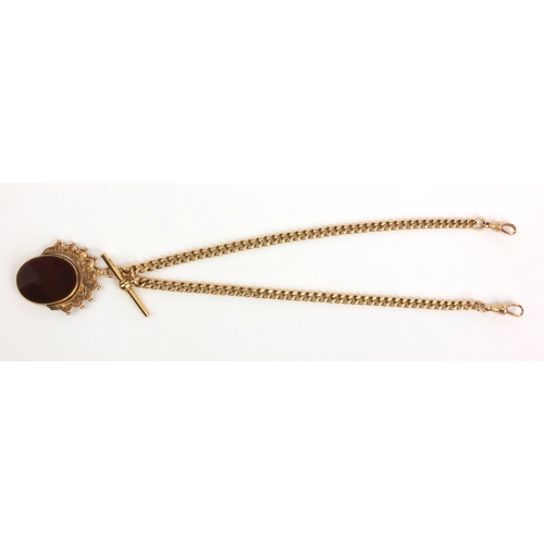 1286 - 15ct gold watch chain with T-bar and large 9ct gold hardstone spinner fob, the chain 36cm long, appr... 