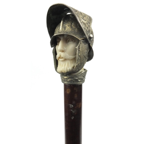 62 - Walking stick, the pommel modelled as a knight's head wearing a helmet, with moveable visor, the sti... 