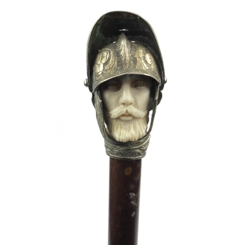 62 - Walking stick, the pommel modelled as a knight's head wearing a helmet, with moveable visor, the sti... 