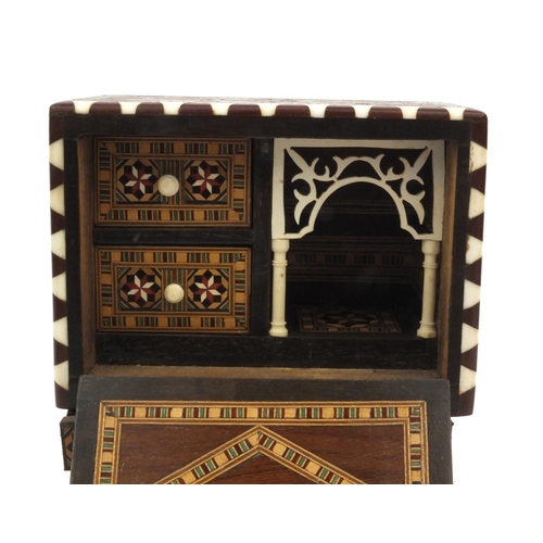 51 - Miniature wooden inlaid cabinet with ivory supports and fitted ivory interior, 22cm high