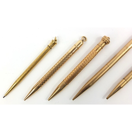 93 - Five propelling pencils including one 9ct gold example, the largest 12cm long