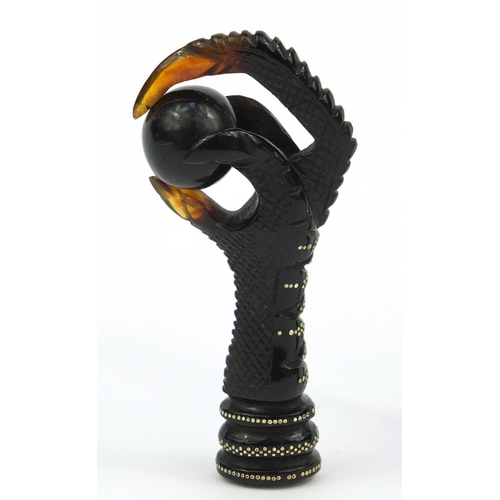 106 - Two tortoiseshell effect claw and ball seals, together with a similar example all inlaid with gold m... 