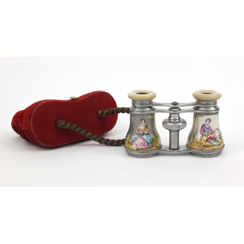 201 - Pair of opera glasses hand painted with lovers, housed in a red velvet case, 10cm long