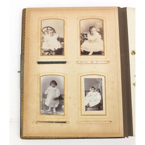 252 - Edwardian leather bound musical cabinet card album containing assorted family photographs, 30cm x 25... 