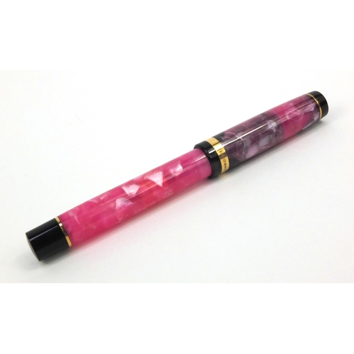 73a - Boxed Conway Stewart limited edition pink marbleised fountain pen 'Duro', the pen with gold band and... 