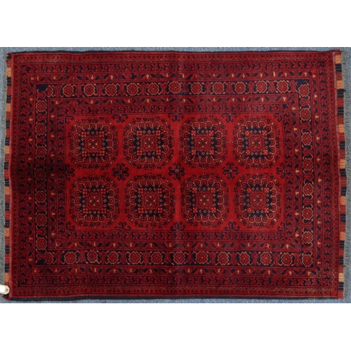 2035 - Rectangular Middle Eastern Qalin rug decorated with geometric shapes onto a red ground, 143cm x 105c... 