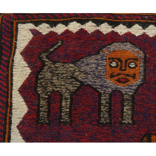 2045 - Rectangular Middle Eastern Qalin rug with geometric border, the central field decorated with lions a... 