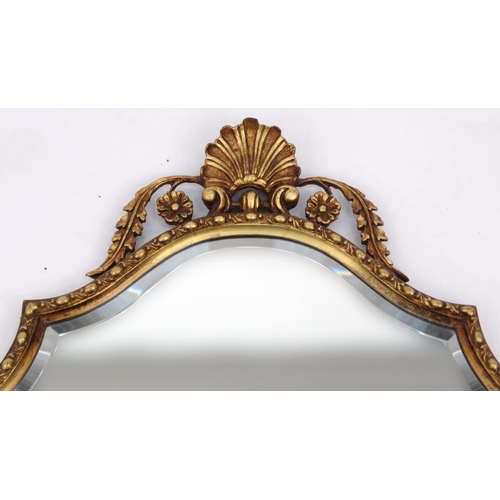2021 - Ornate gilt framed shaped bevel edged mirror with shell crest, 77cm high
