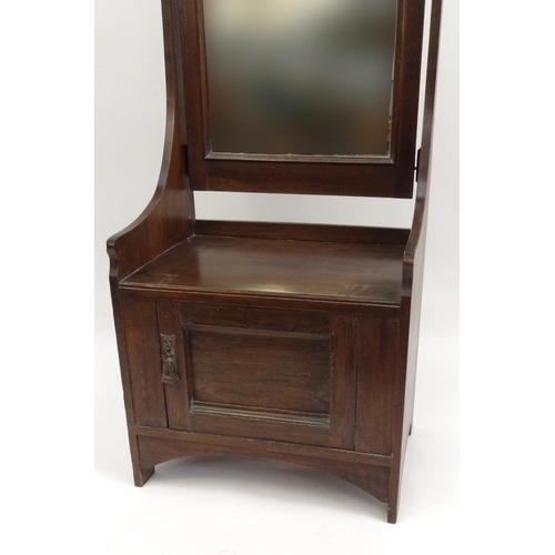 2036 - Arts and crafts oak hall mirror with brass plaque and cupboard base, 180cm high x 61cm wide x 43cm d... 
