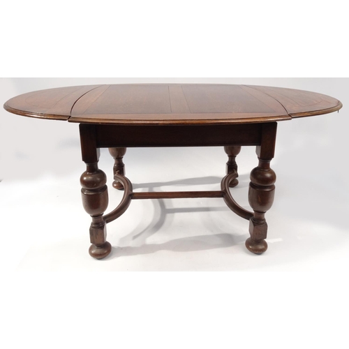 2008 - 1930s oak drawleaf dining table and six chairs with brown leather drop in seats, the table 76cm high... 