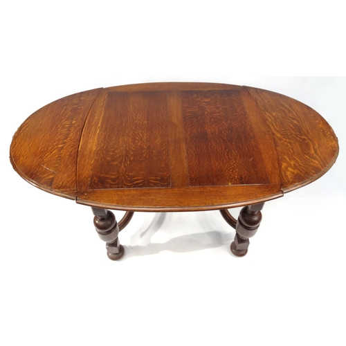 2008 - 1930s oak drawleaf dining table and six chairs with brown leather drop in seats, the table 76cm high... 
