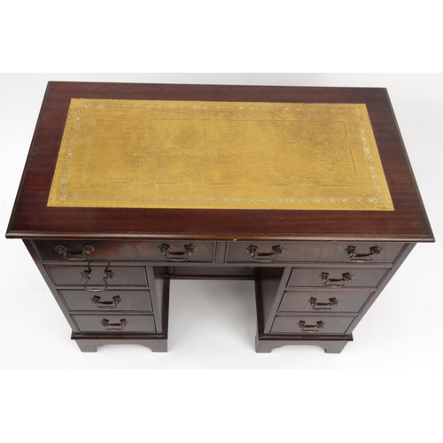 2020 - Mahogany kneehole desk with tooled leather insert top and fitted with eight drawers, 76cm high x 93c... 