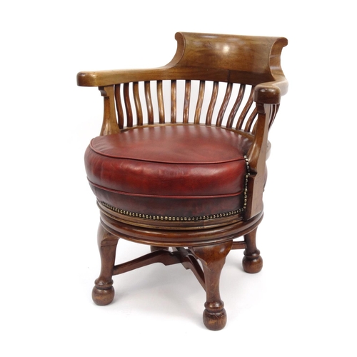 2005 - Mahogany swivel captain's chair with red leather seat