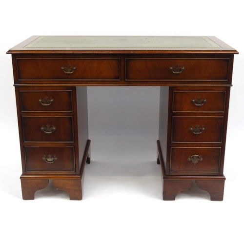 2002 - Mahogany twin pedestal desk with tooled leather top fitted with eight drawers, 79cm high x 106cm wid... 