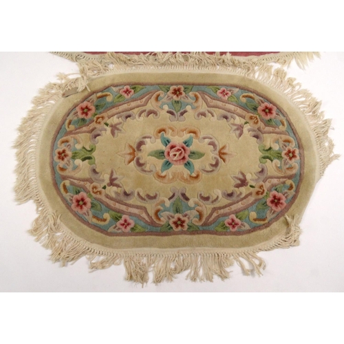 25 - Two oval floral rugs, the larger 160cm x 100cm
