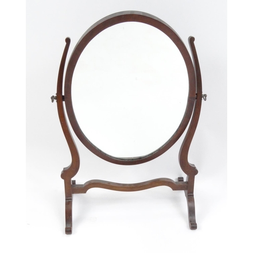 27 - Oval mahogany swing mirror, 60cm high