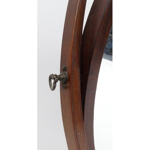 27 - Oval mahogany swing mirror, 60cm high
