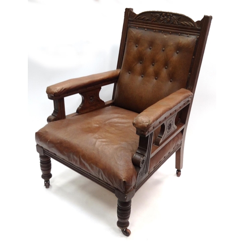 44 - Carved oak framed armchair with brown leatherette buttonback upholstery
