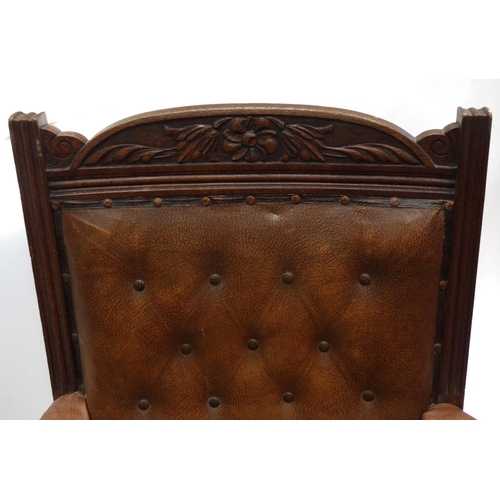 44 - Carved oak framed armchair with brown leatherette buttonback upholstery