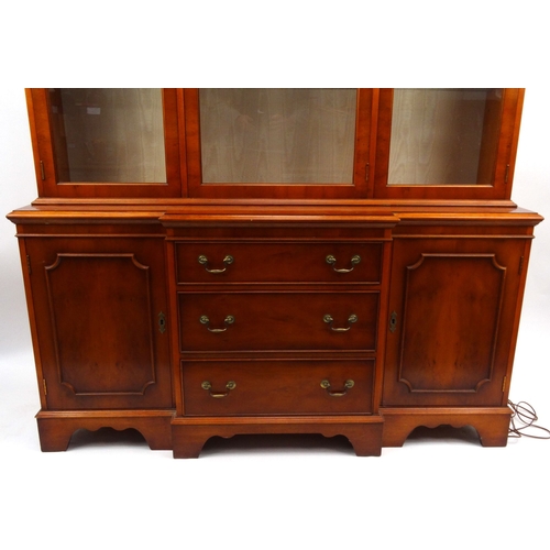 37 - Yew wood wall unit fitted with glazed doors above cupboard doors and drawers, 190cm high x 150cm wid... 
