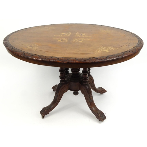 54A - Oval inlaid walnut loo table with quarter veneered top, the top 118cm x 84cm