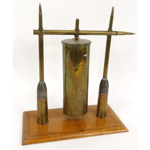 750 - Military interest trench art table gong raised on an oak plinth, 44cm high