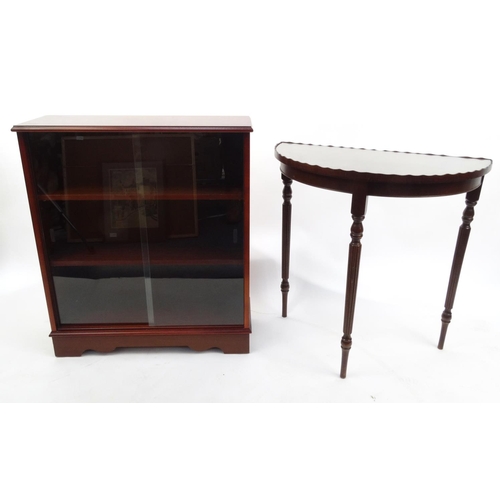 103 - Mahogany bookcase fitted with sliding glass doors and a mahogany demi lune hall table