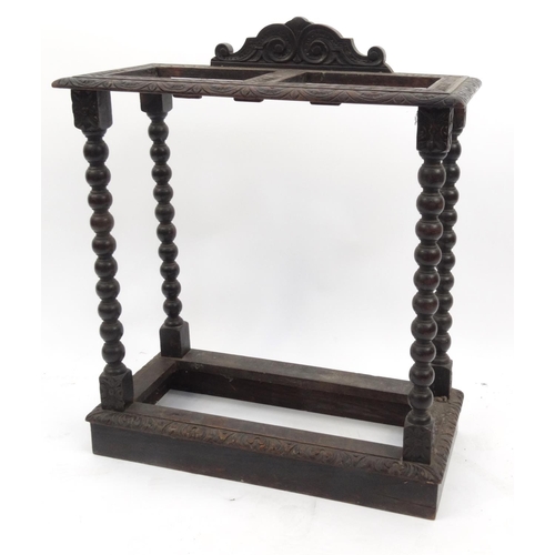 82 - Carved oak stick stand with bobbin turned supports, 75cm high x 62cm wide x 29cm deep
