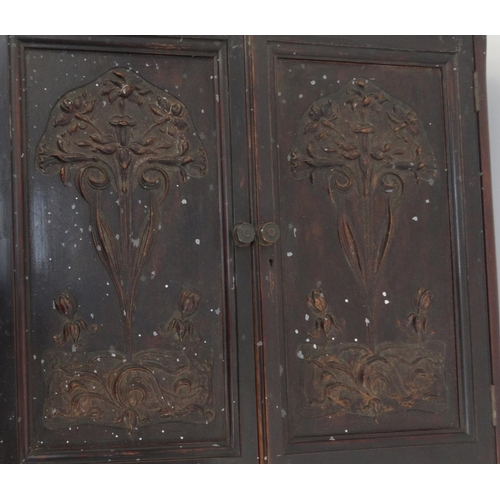 74 - Carved mahogany two door wall hanging cupboard enclosing three drawers and shelves, 70cm high x 53cm... 