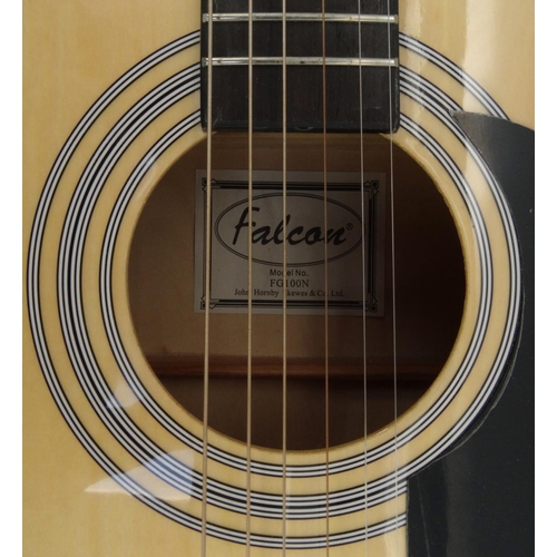 157 - Falcon wooden acoustic guitar with carry case, model number FG100N