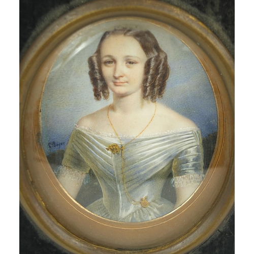 9 - Miniature watercolour of a young girl, G. Soyet , mounted in a black wooden frame, 7.5cm high