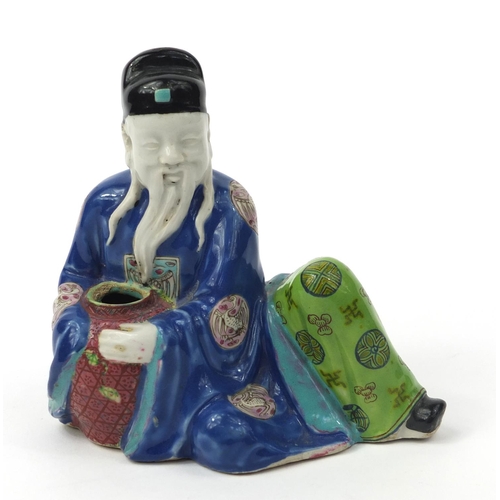 575 - Oriental Chinese stoneware seated elder holding a vessel, hand painted with famille rose decoration,... 