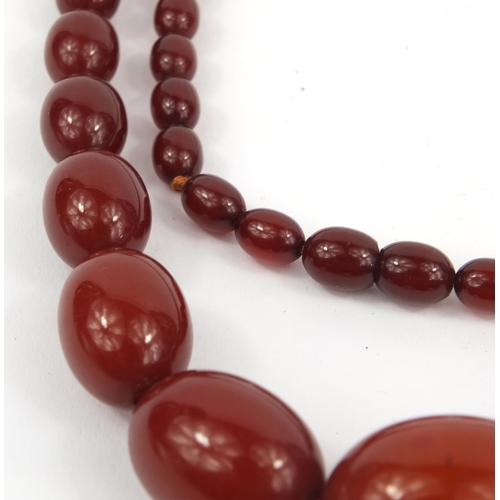 1170 - Cherry amber coloured bead necklace, 96cm long, approximate weight 64.2g