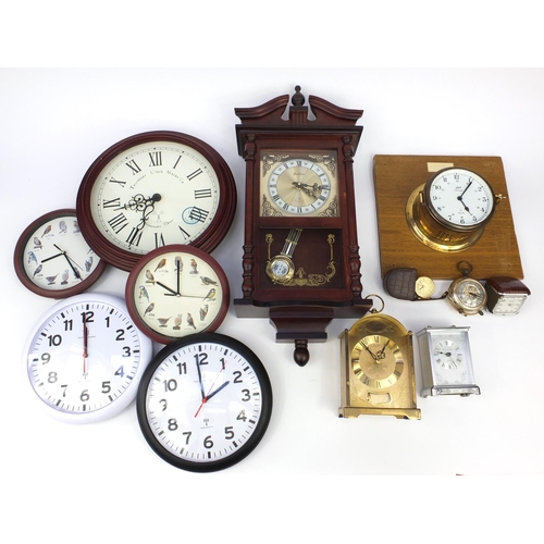 215 - Collection of decorative wall clocks, brass mantel clock and a ship's design clock