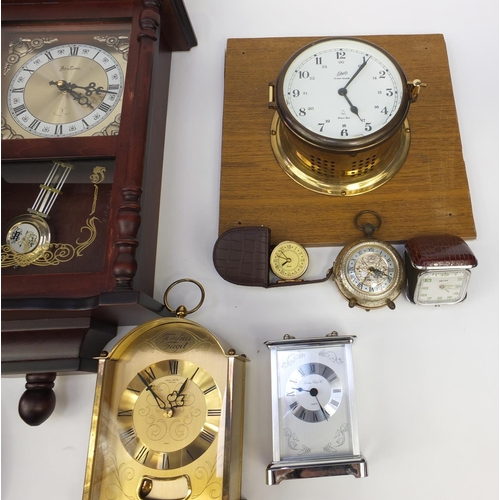 215 - Collection of decorative wall clocks, brass mantel clock and a ship's design clock