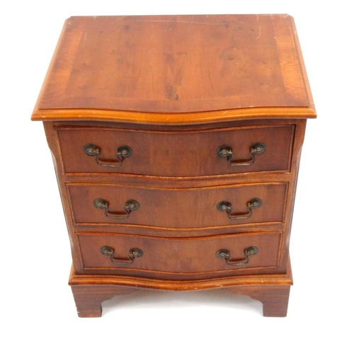 46 - Yew wood serpentine front three drawer chest, 59cm high x 49cm wide x 39cm deep