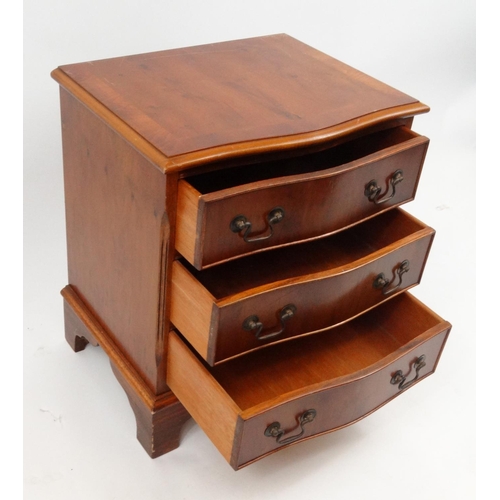 46 - Yew wood serpentine front three drawer chest, 59cm high x 49cm wide x 39cm deep
