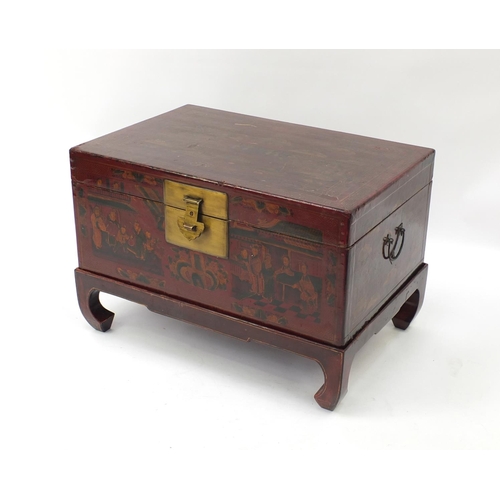 35 - Oriental red lacquered chest on stand decorated with figures in a landscape, 50cm high x 73cm wide x... 