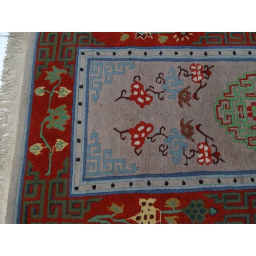 93 - Geometric patterned beige and red ground rug, approximately 175cm x 90cm