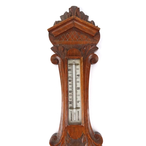 296 - Carved oak aneroid barometer, 71cm long