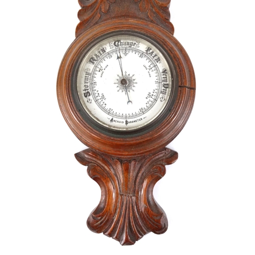 296 - Carved oak aneroid barometer, 71cm long