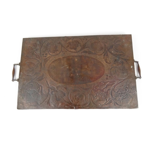 294 - Arts and Crafts rectangular copper tray with embossed floral decoration, 65cm long