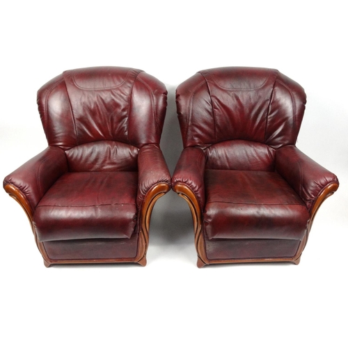 31 - Mahogany framed burgundy leather three seater settee and two armchairs