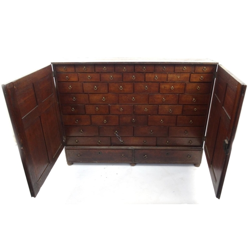 2 - Georgian oak multi draw cabinet with panelled doors, possibly originally part of a chemists shop fit... 