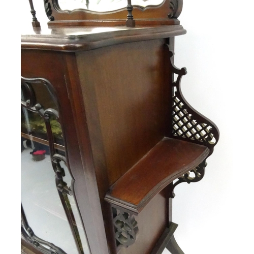 9 - Ornate Edwardian mahogany display cabinet with mirrored back and glazed door enclosing two velvet li... 